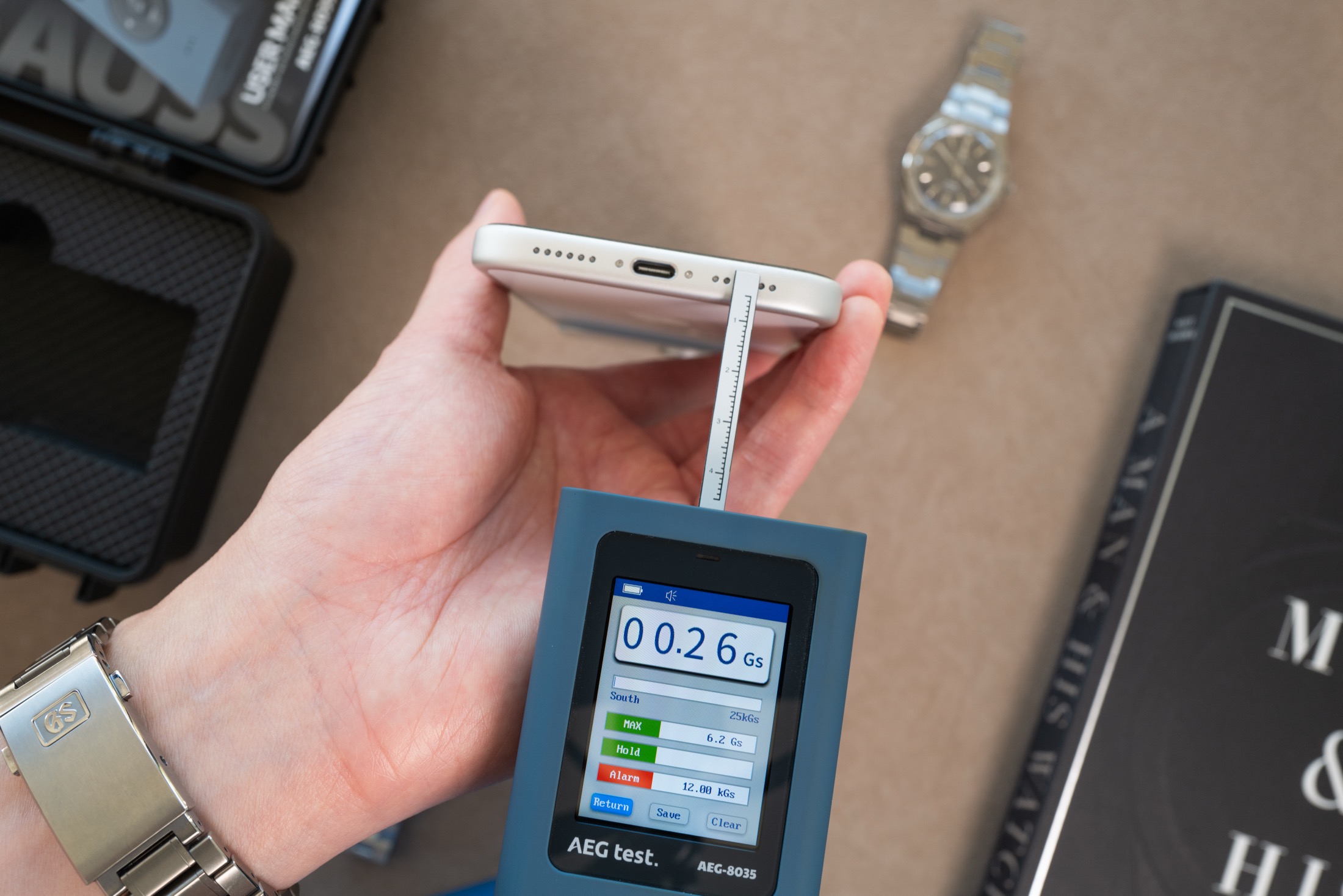 Gaussmeter probe measuring iPhone bottom edge right side, display showing 0.26 Gauss