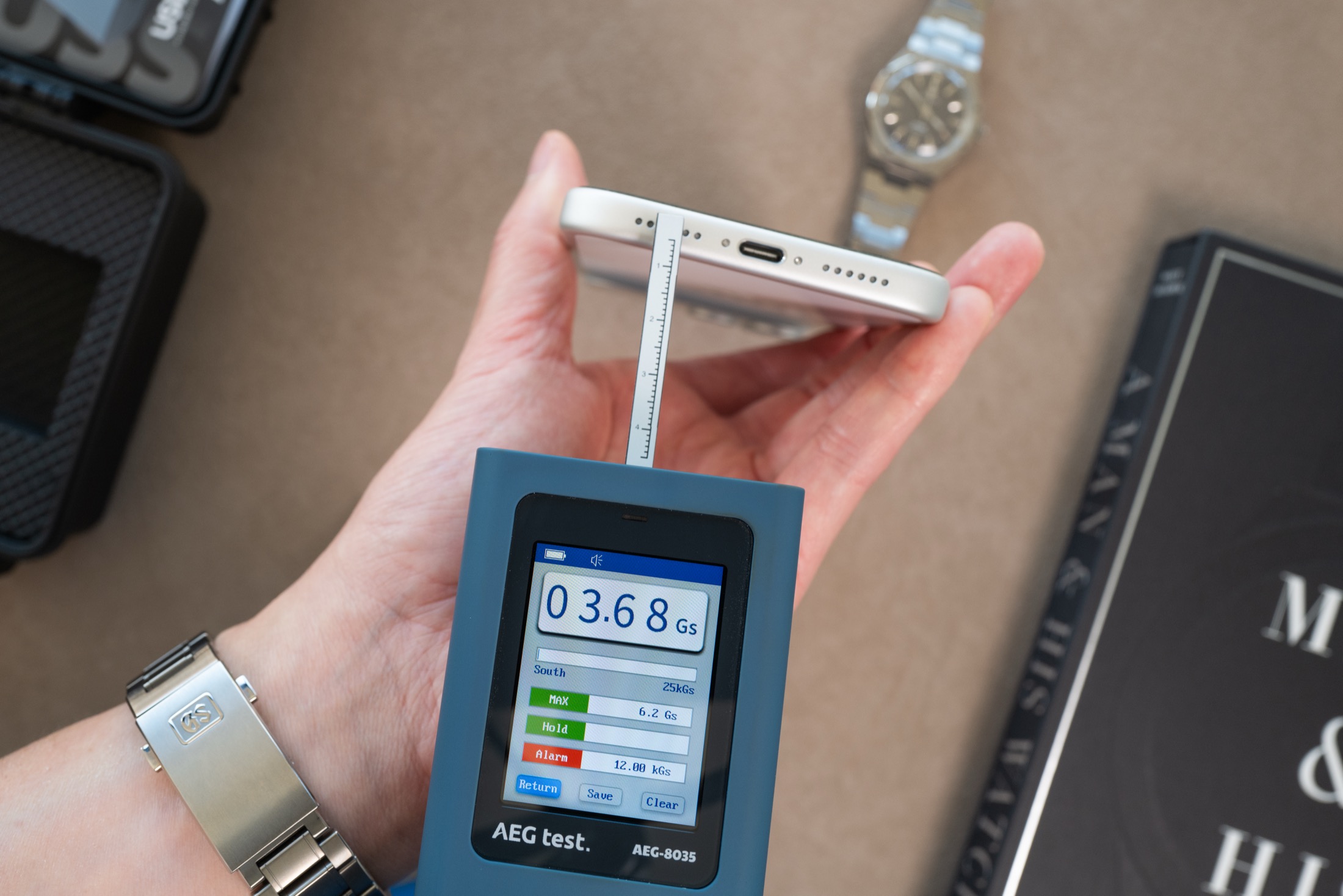 Gaussmeter probe measuring iPhone bottom edge left side, display showing 3.68 Gauss